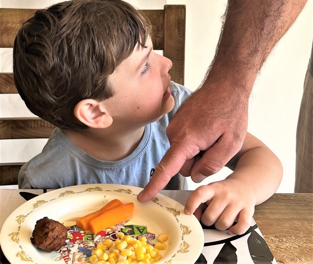 Boy being told to eat.