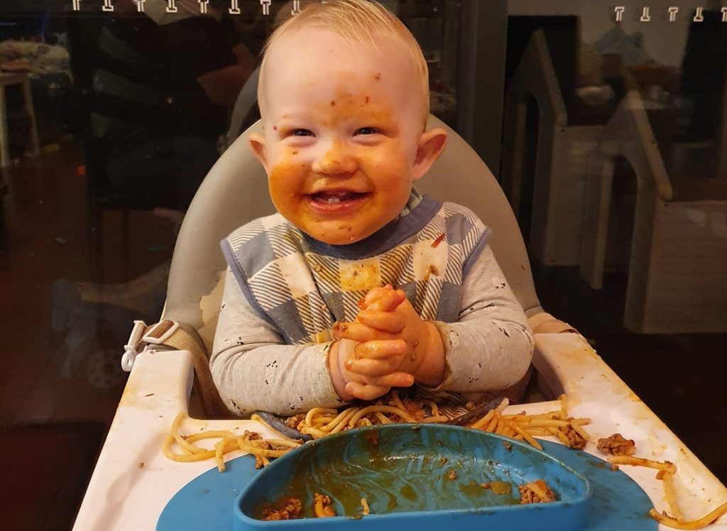 Child messy with spaghetti all over them 